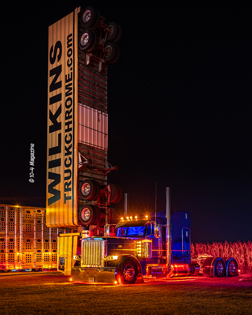 night time view of the wilkins verticle semi truck and another semi truck. 